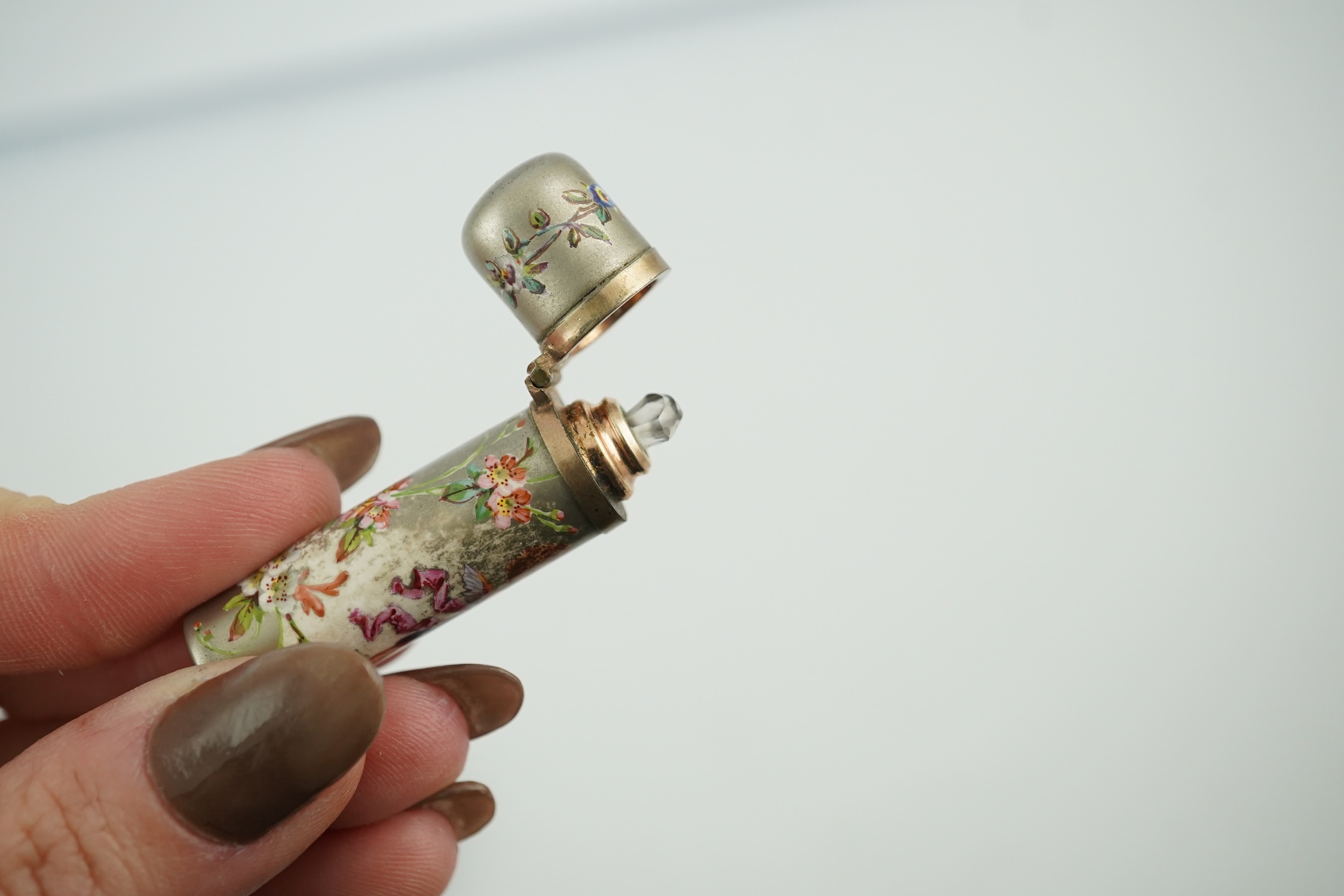 A Victorian white metal and enamel cylindrical scent bottle, 48mm (a.f.) and a late Victorian silver mounted willow pattern scent flask. Condition - poor to fair